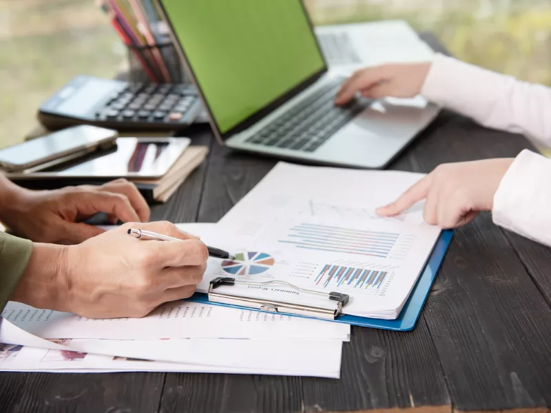 Professionals reviewing charts and data for KA02 report writing services documentation